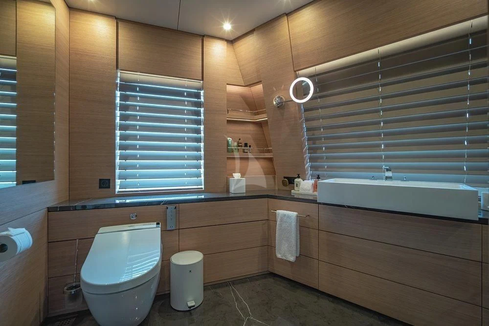 a bathroom with a toilet and bathtub aboard WANDERLUST Yacht for Charter