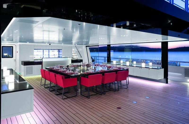 a room with red tables and chairs aboard WANDERLUST Yacht for Charter