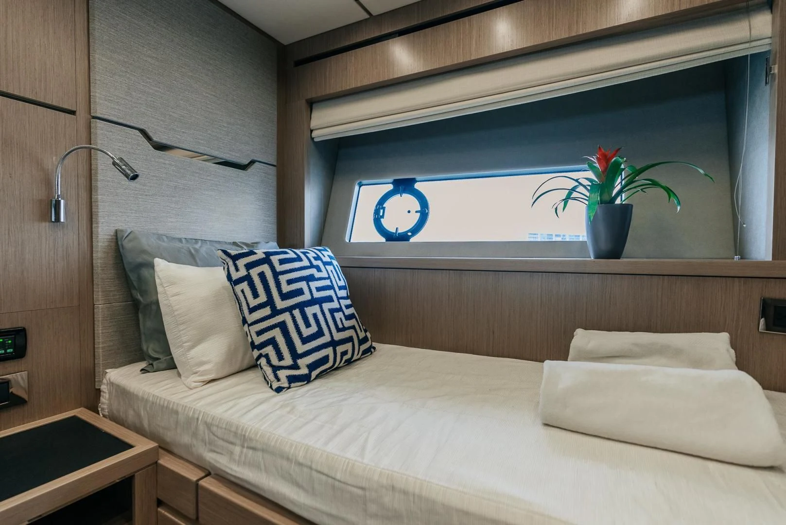 a bed with pillows and a plant aboard GRAVITAS Yacht for Charter