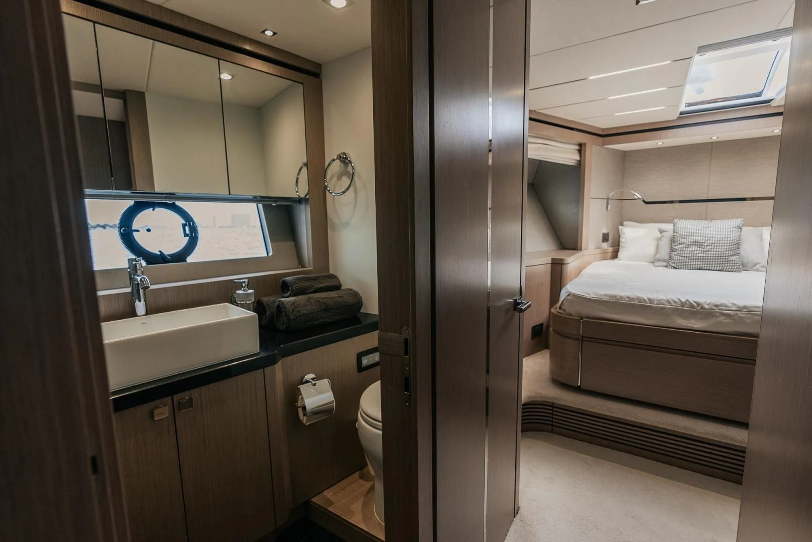 a bathroom with a sink and a bed aboard GRAVITAS Yacht for Charter