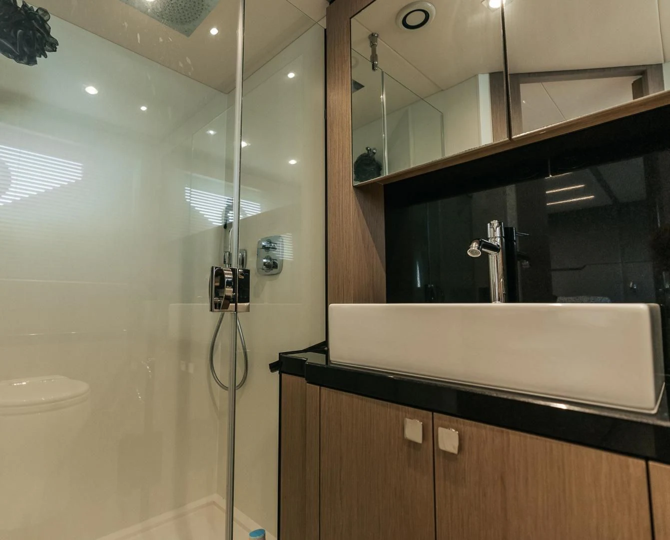 a bathroom with a shower unit aboard GRAVITAS Yacht for Charter
