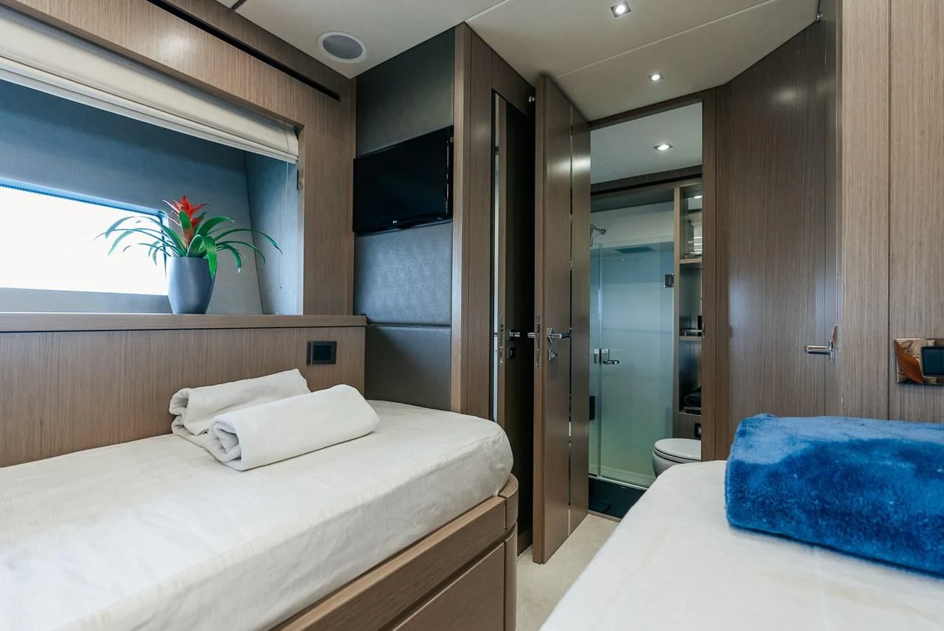 a bedroom with a bed and a television aboard GRAVITAS Yacht for Charter