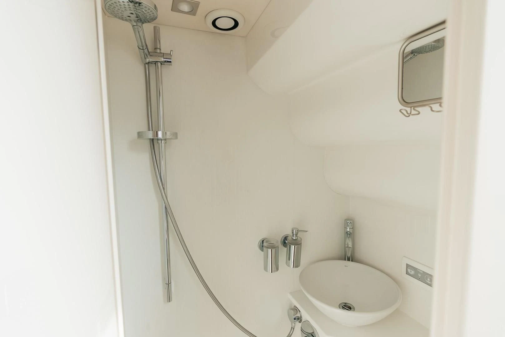 a shower with a sink and a mirror aboard GRAVITAS Yacht for Charter