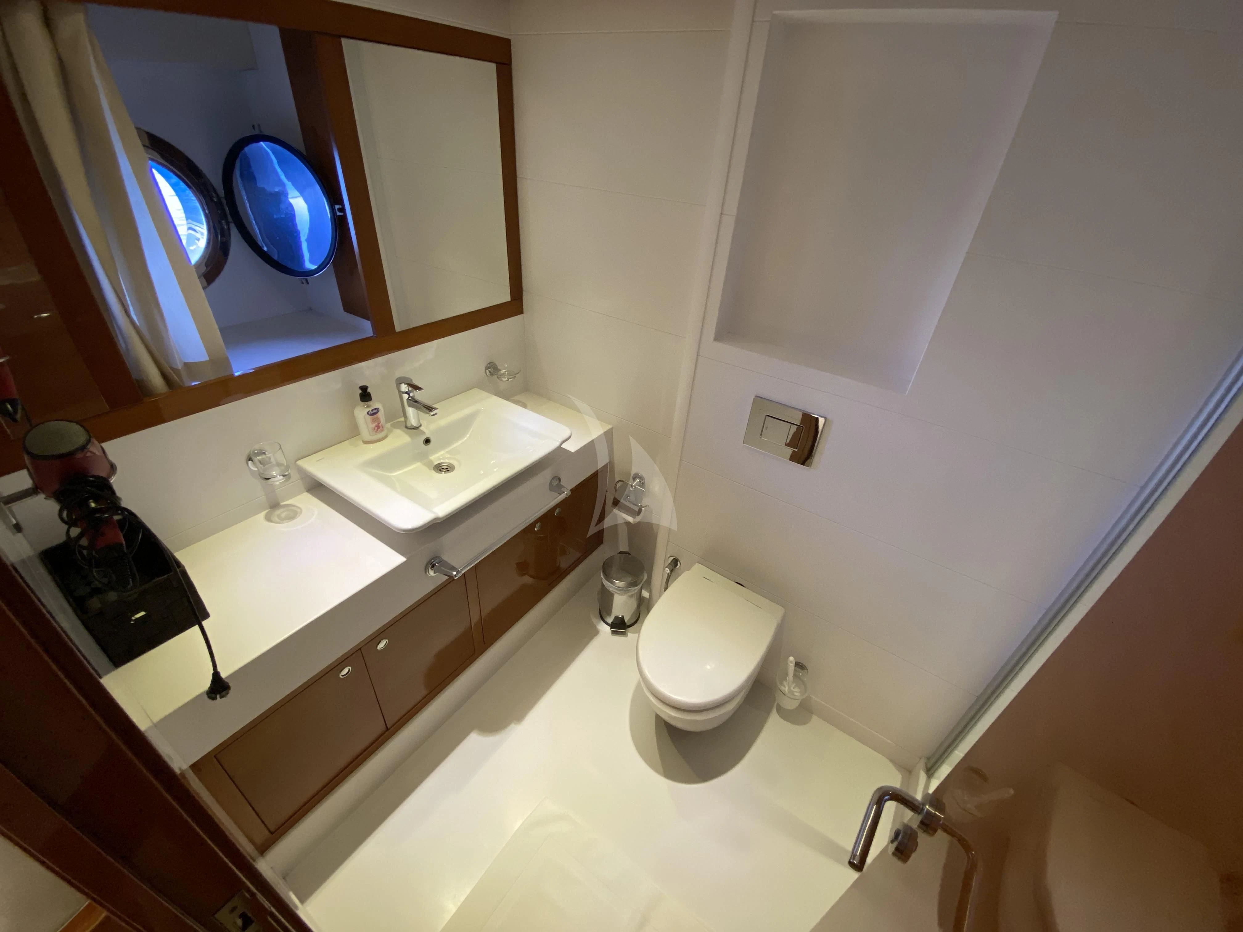 a bathroom with a toilet and a sink aboard CANARIA Yacht for Sale
