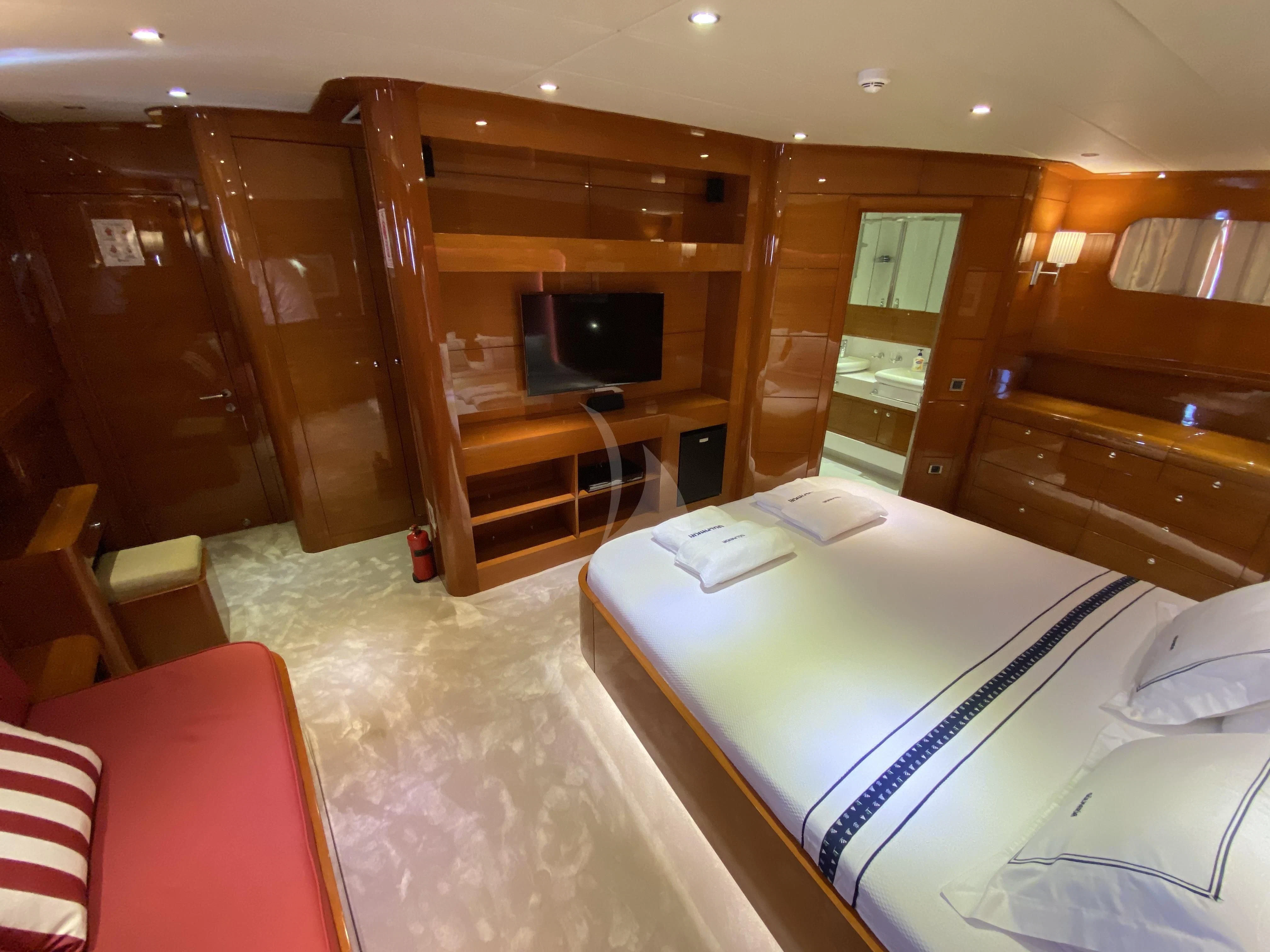 a room with a bed and a television aboard CANARIA Yacht for Sale