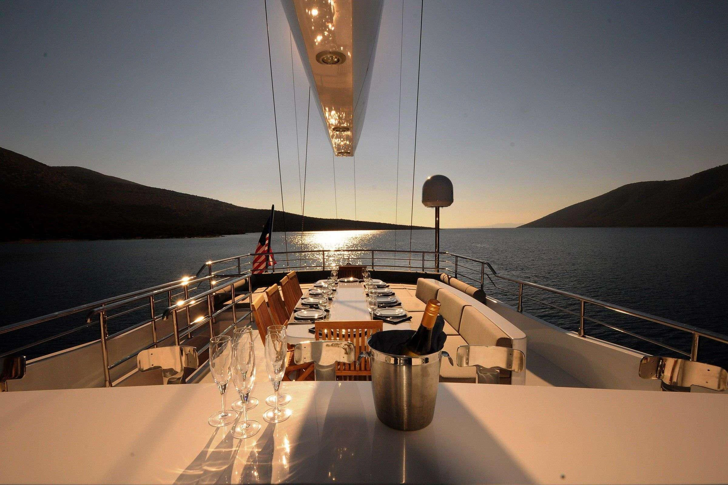 a boat with a table and chairs on it aboard CANARIA Yacht for Sale