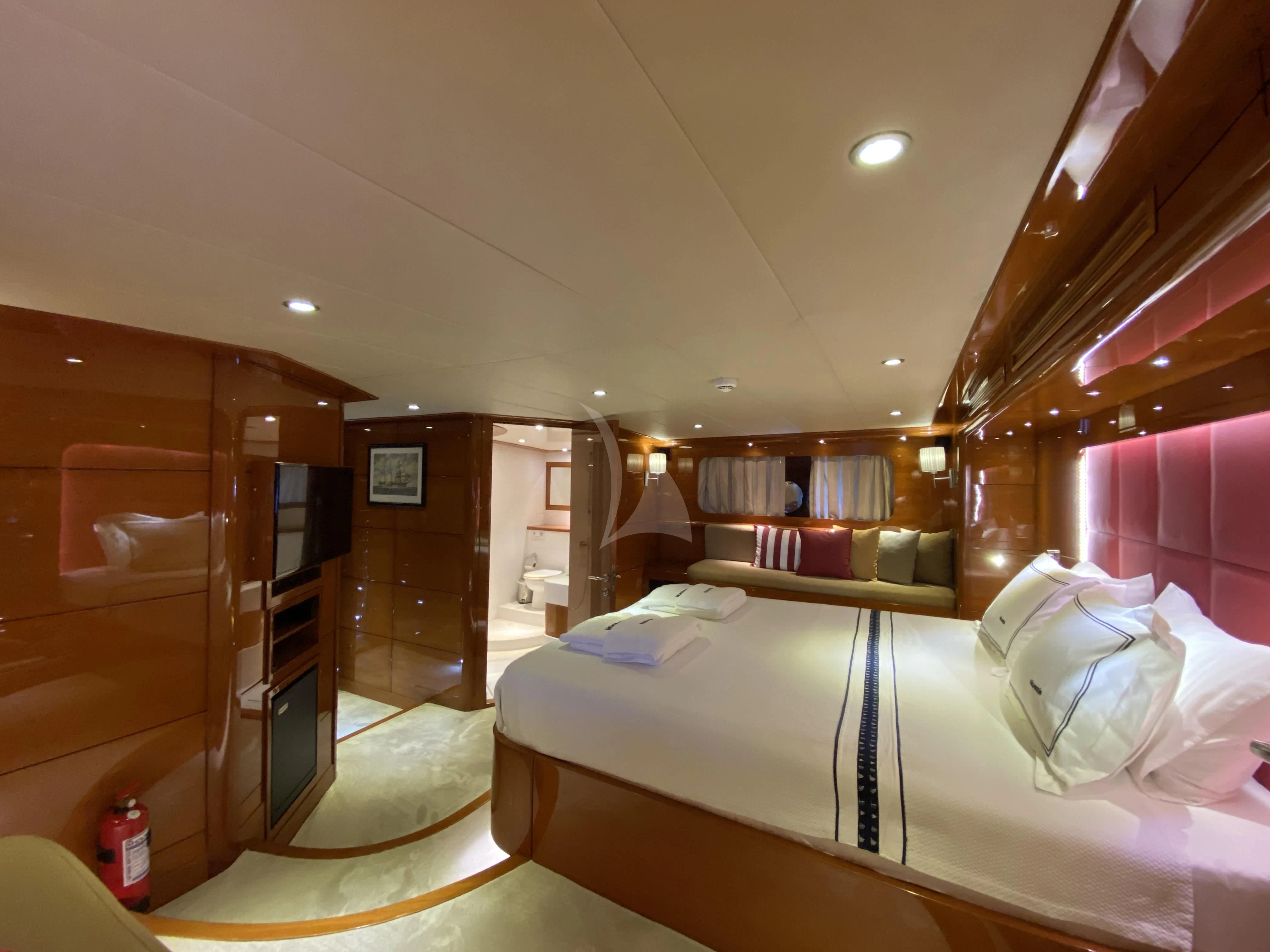 a bedroom with a bed and a mirror aboard CANARIA Yacht for Sale