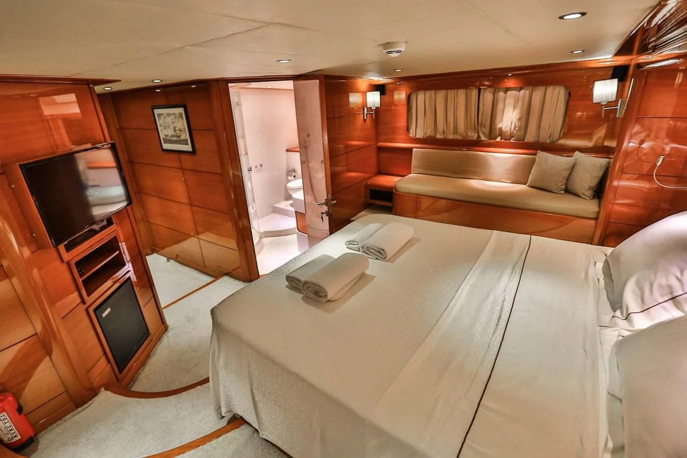 a room with a bed and a couch aboard CANARIA Yacht for Sale