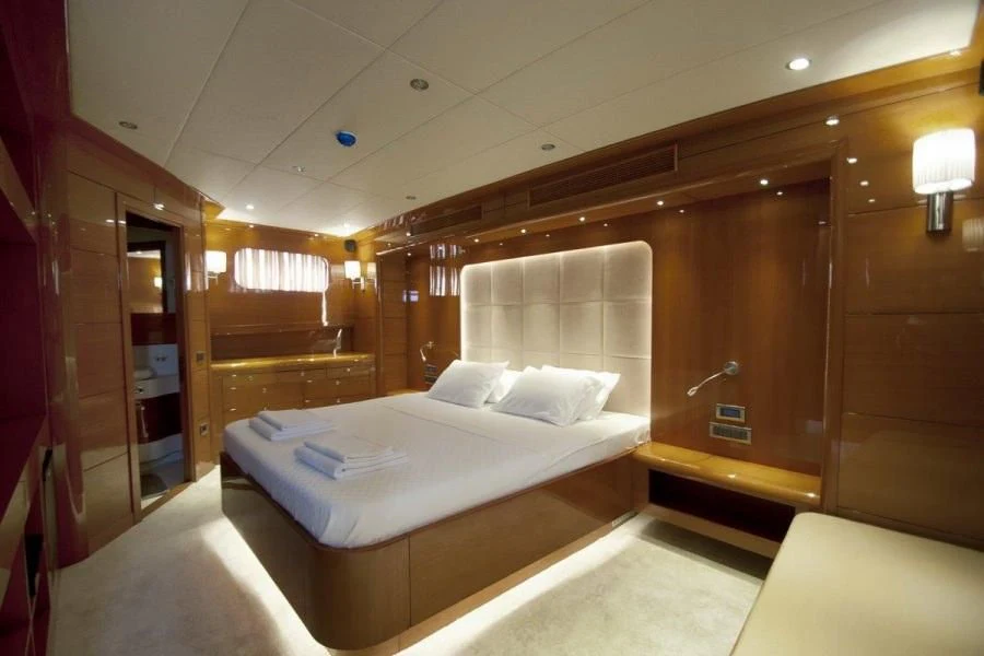 a room with a bed and a desk aboard CANARIA Yacht for Sale