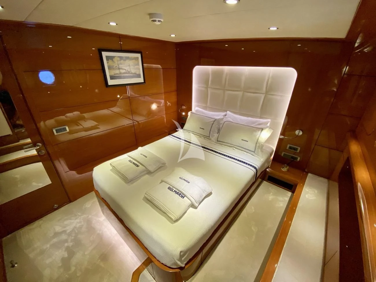a room with a bed and a mirror aboard CANARIA Yacht for Sale