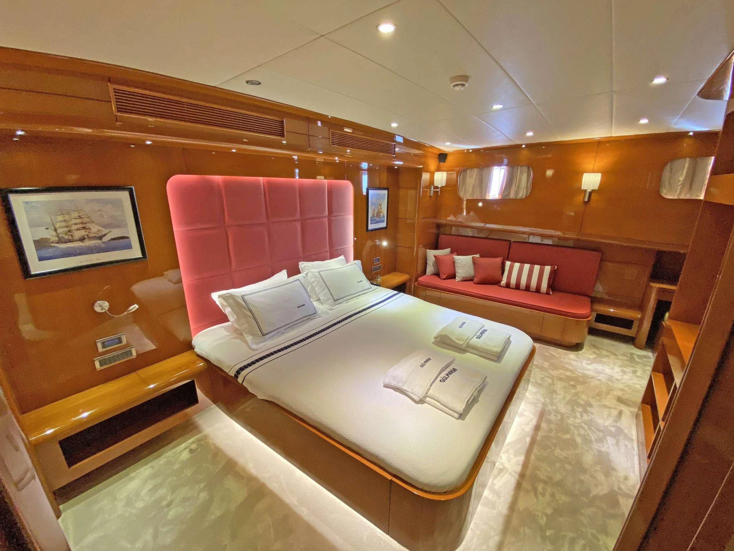a room with a bed and a couch aboard CANARIA Yacht for Sale