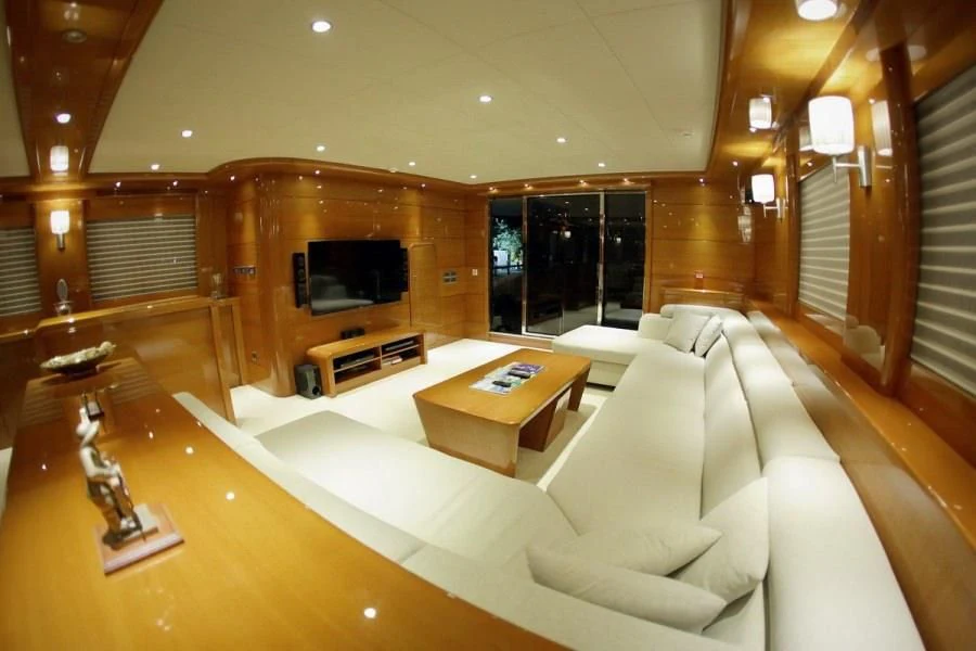 a living room with a couch and a television aboard CANARIA Yacht for Sale