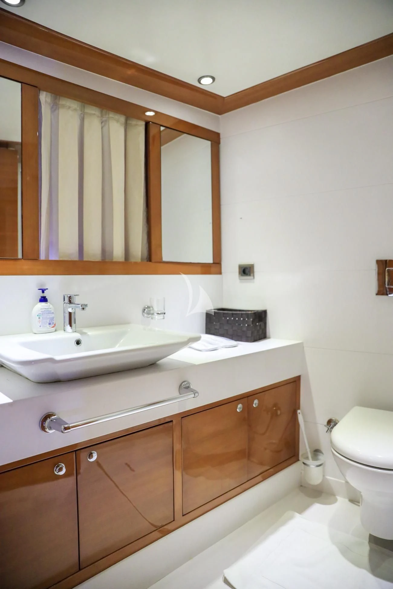 a bathroom with a mirror and a sink aboard CANARIA Yacht for Sale