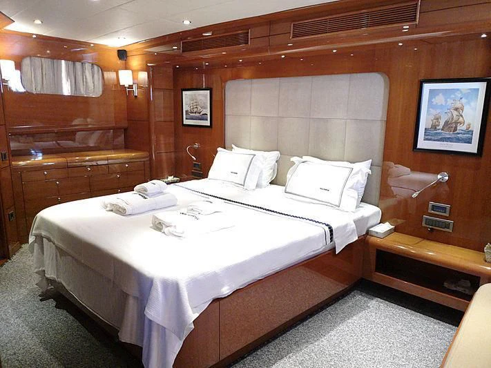 a room with a bed and a chair aboard CANARIA Yacht for Sale