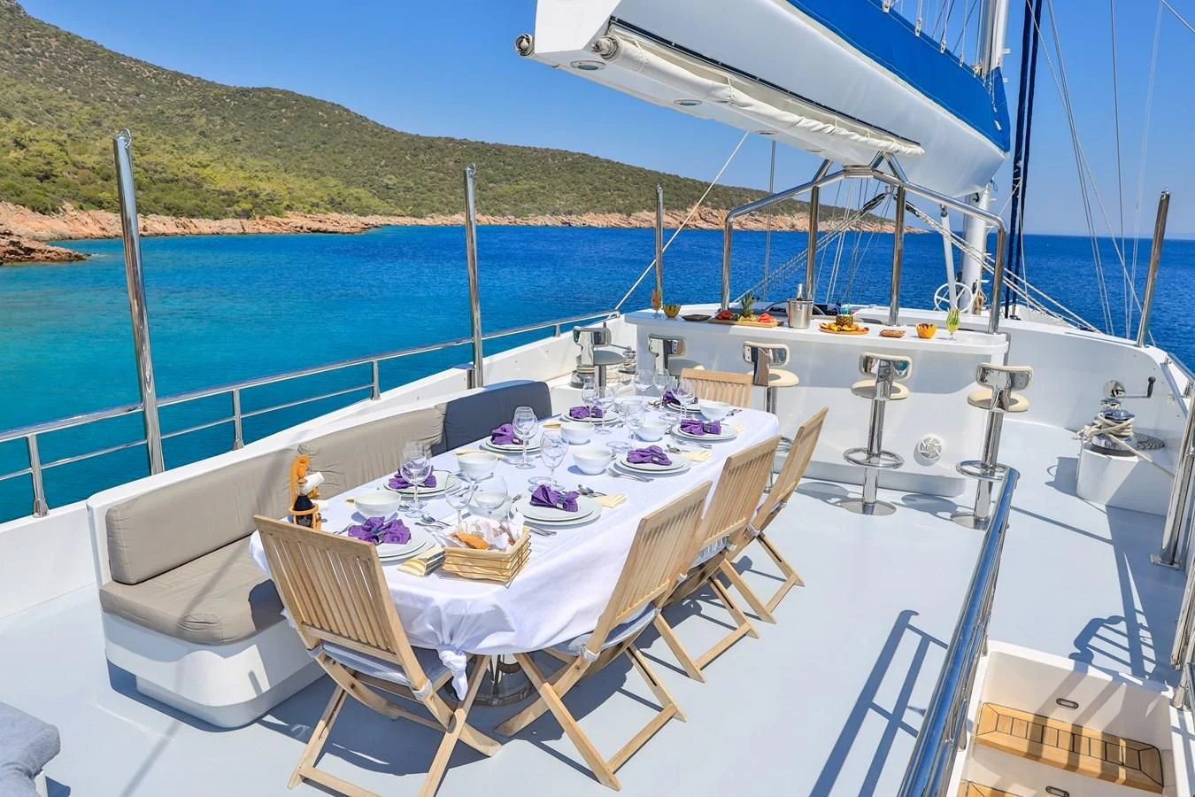 a table set for a meal on a boat aboard CANARIA Yacht for Sale