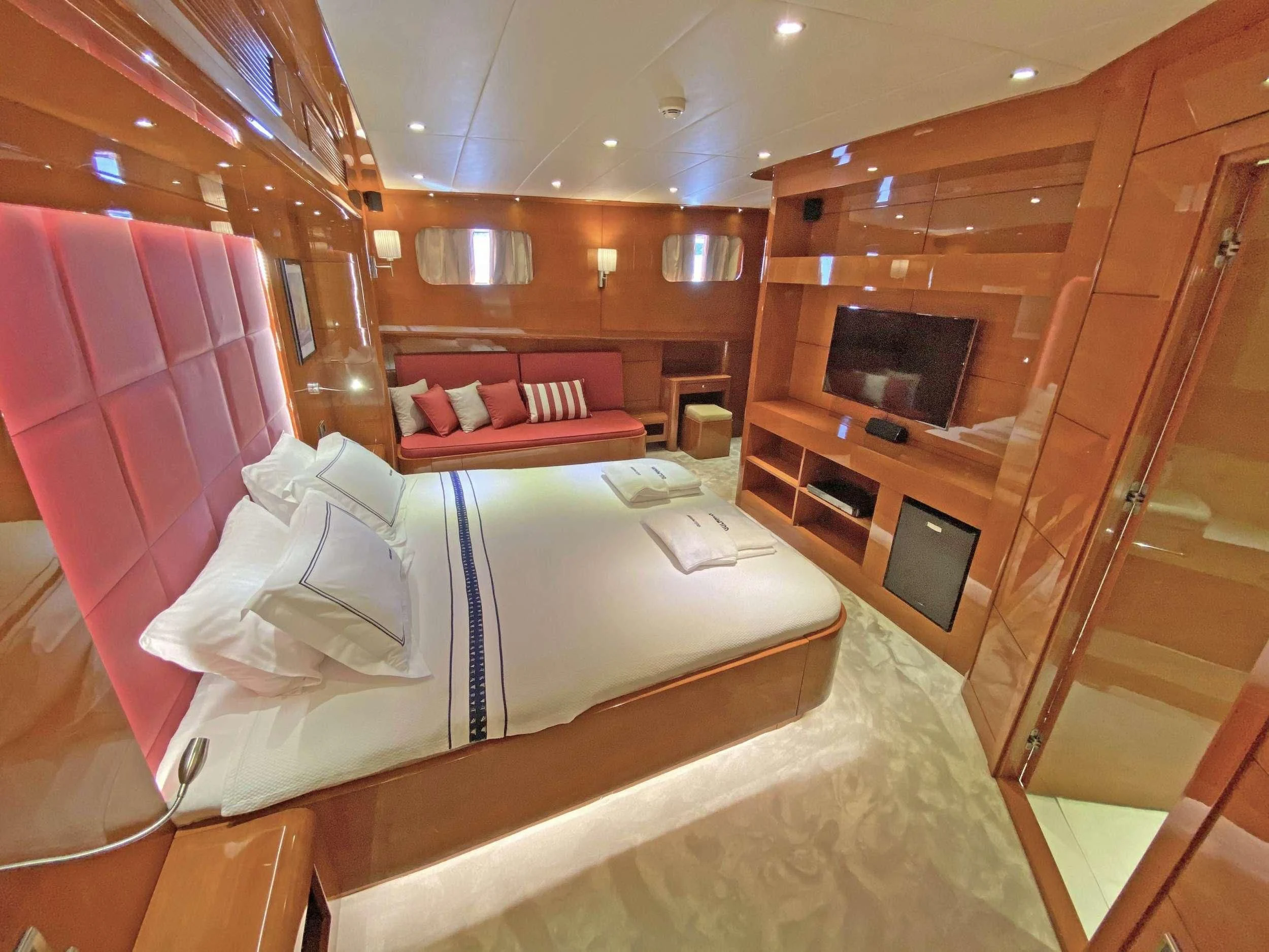 a room with a bed and a fireplace aboard CANARIA Yacht for Sale