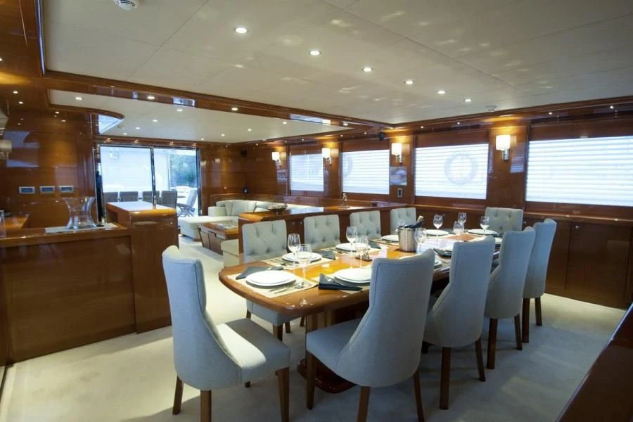 a large room with tables and chairs aboard CANARIA Yacht for Sale
