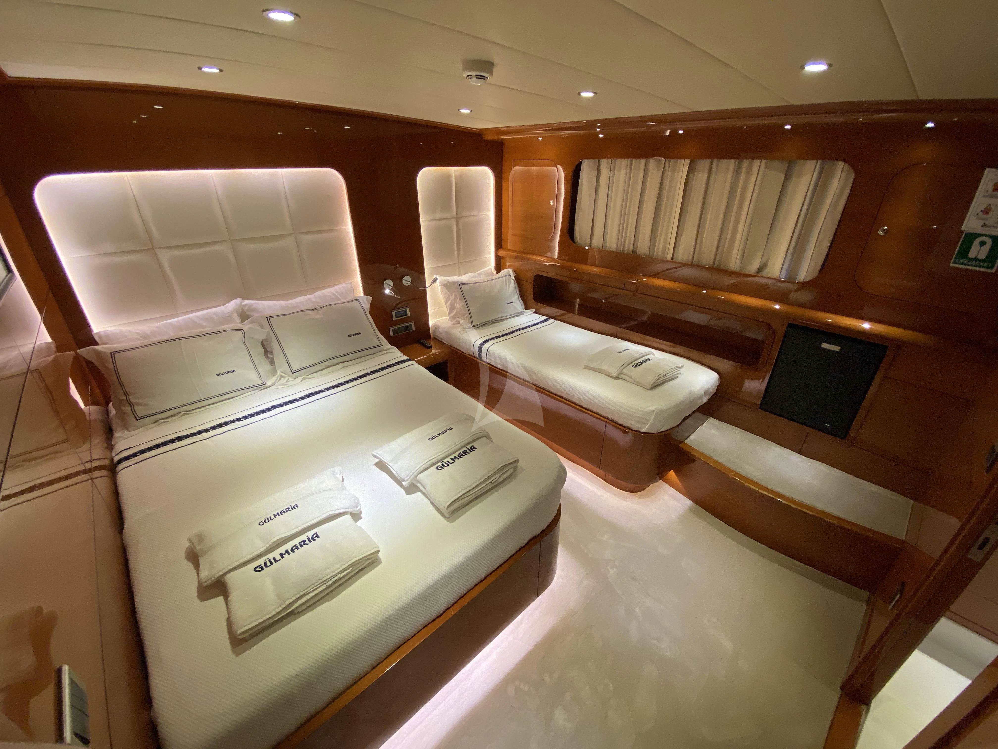 a room with beds and a couch aboard CANARIA Yacht for Sale