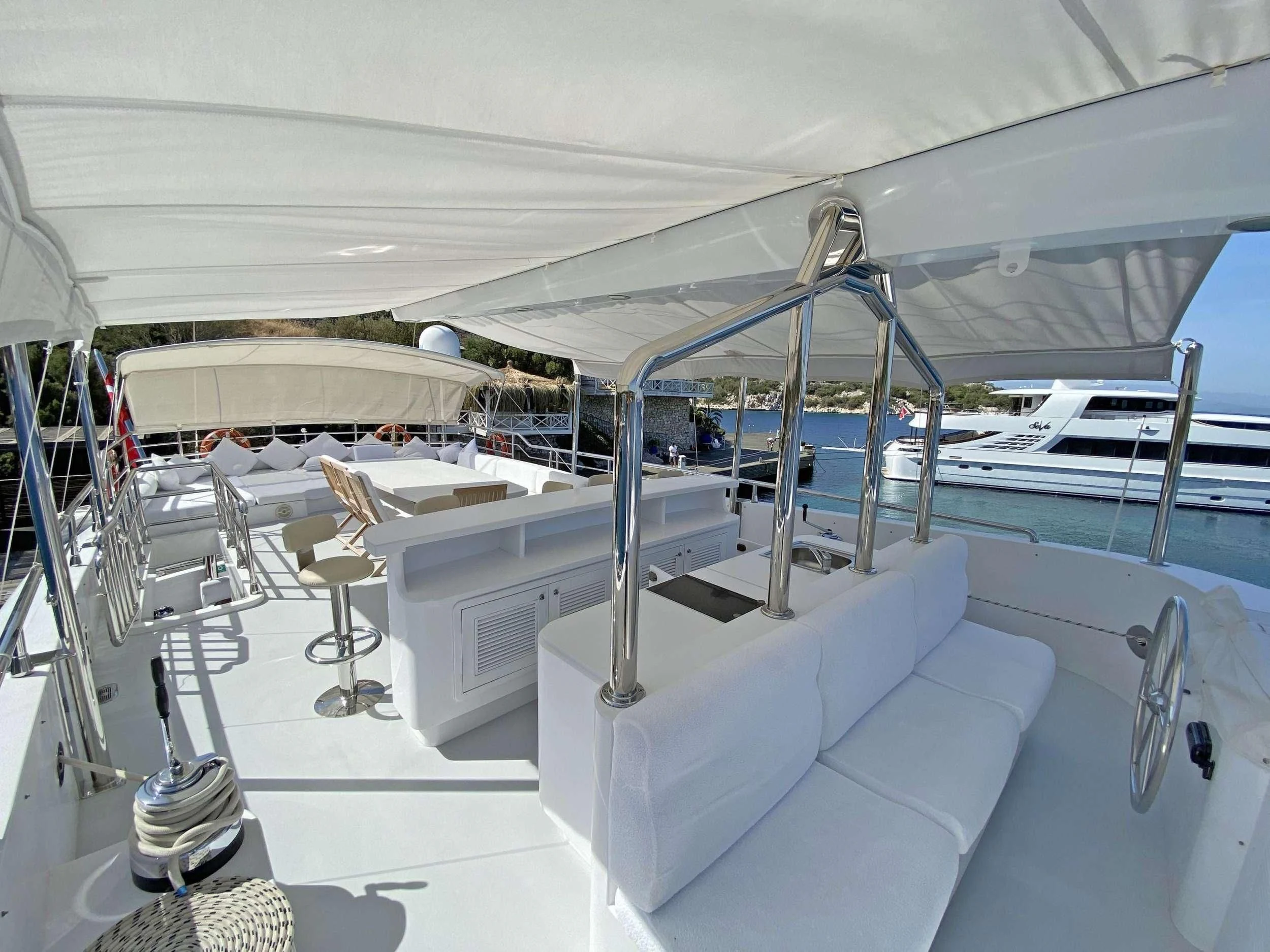 a large white tent with chairs and tables aboard CANARIA Yacht for Sale