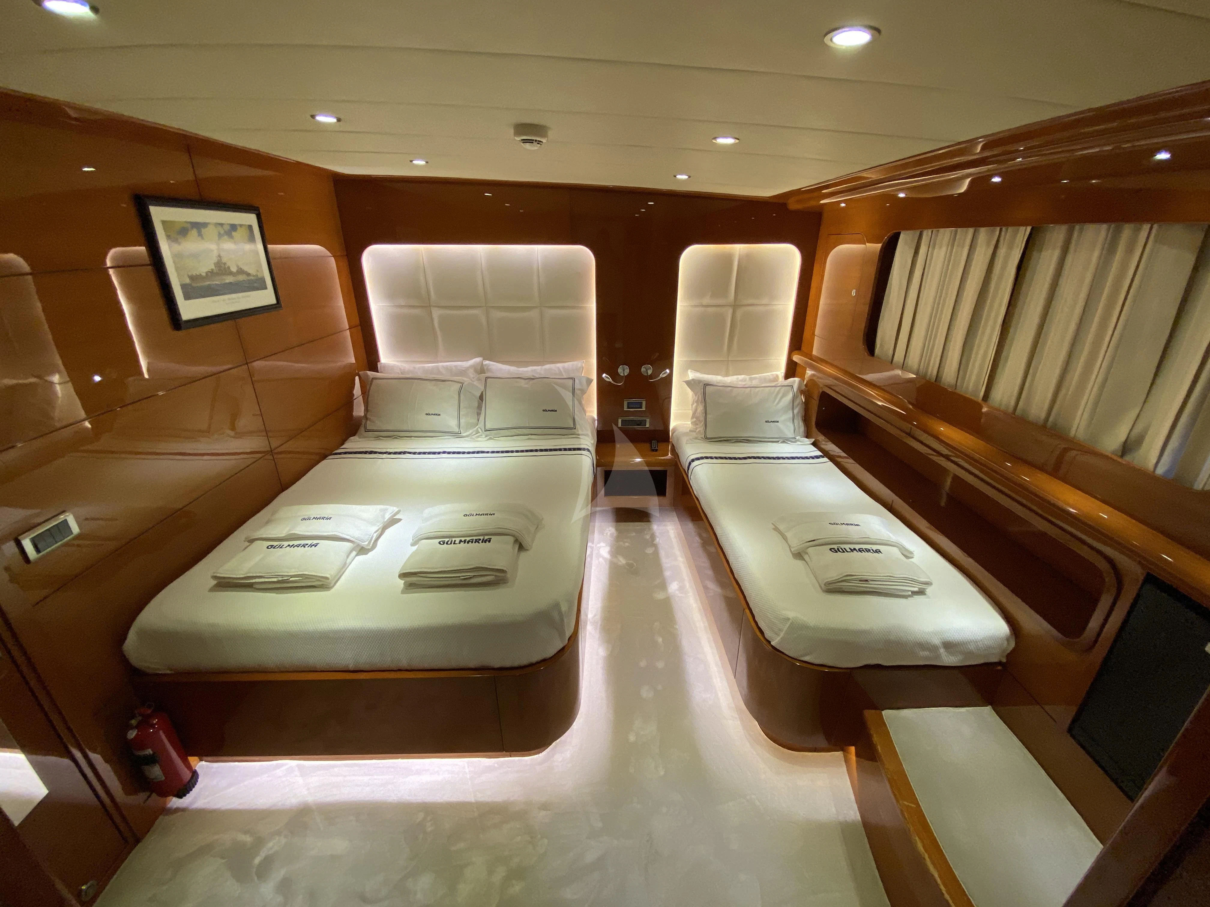 a room with a bed and a couch aboard CANARIA Yacht for Sale