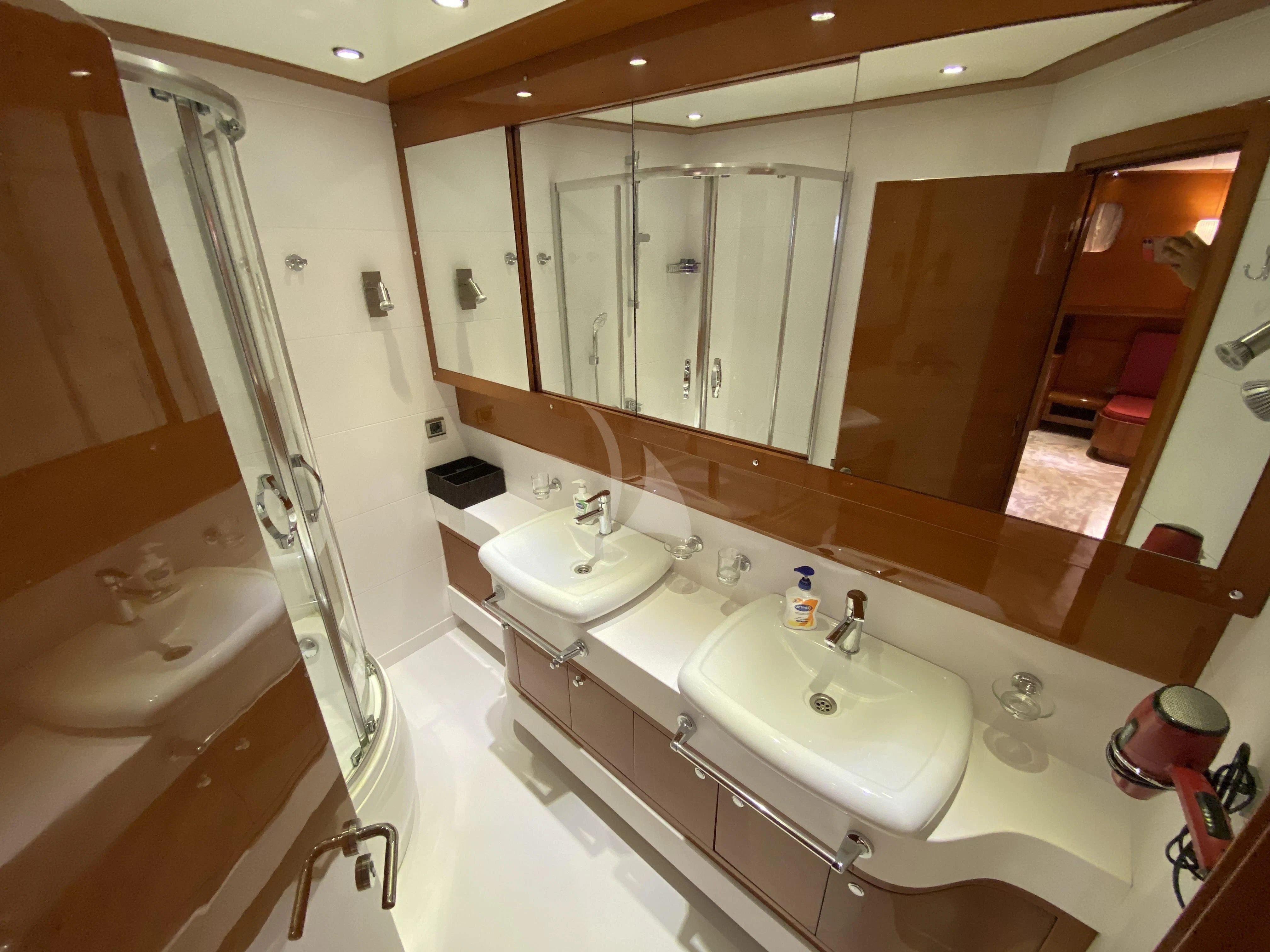 a bathroom with a tub sink and a shower aboard CANARIA Yacht for Sale