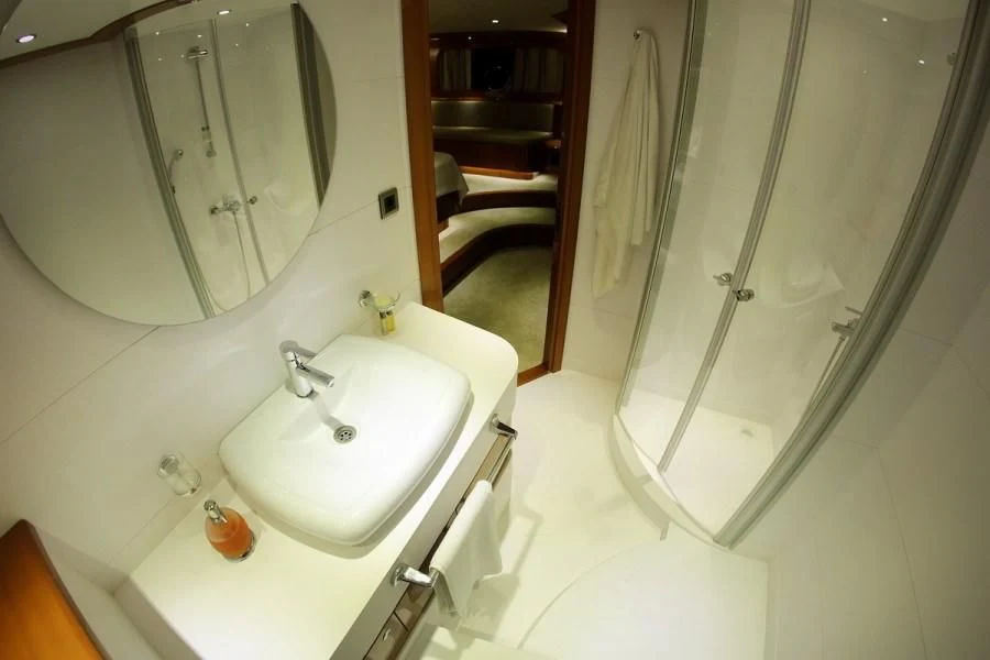 a bathroom with a sink and a mirror aboard CANARIA Yacht for Sale