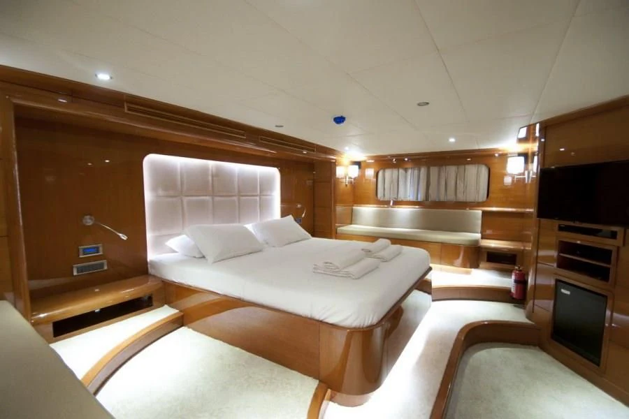 a room with a bed and a television aboard CANARIA Yacht for Sale