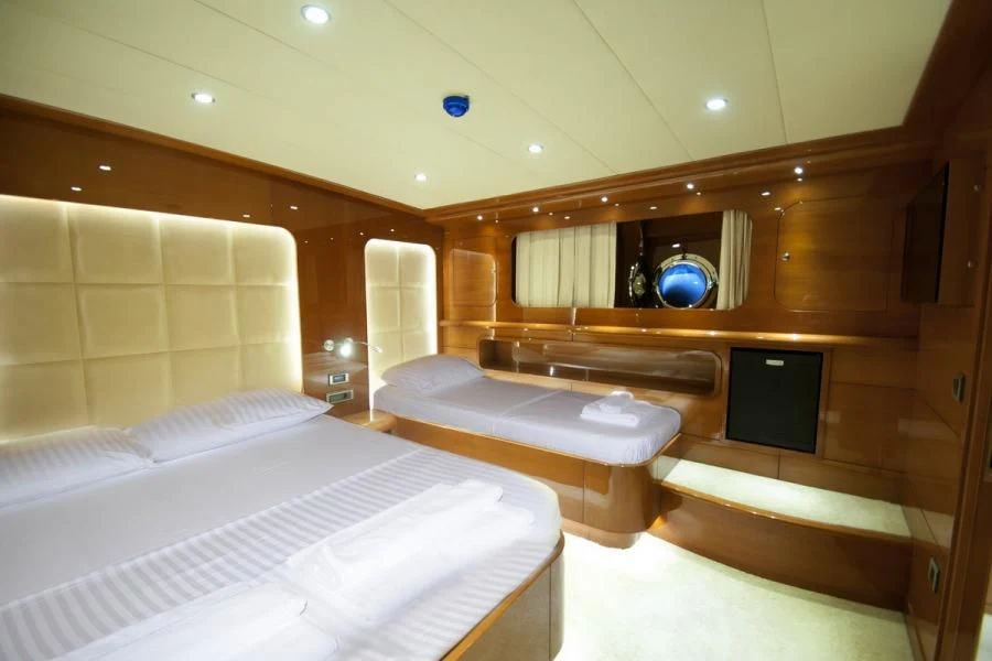 a room with a bed and a television aboard CANARIA Yacht for Sale