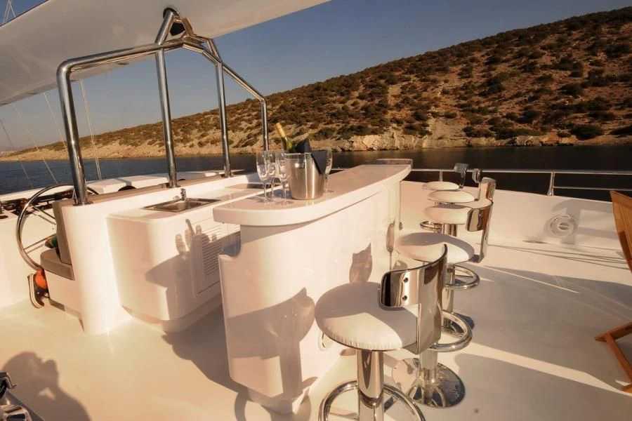 a white table with a couple of glasses on it aboard CANARIA Yacht for Sale