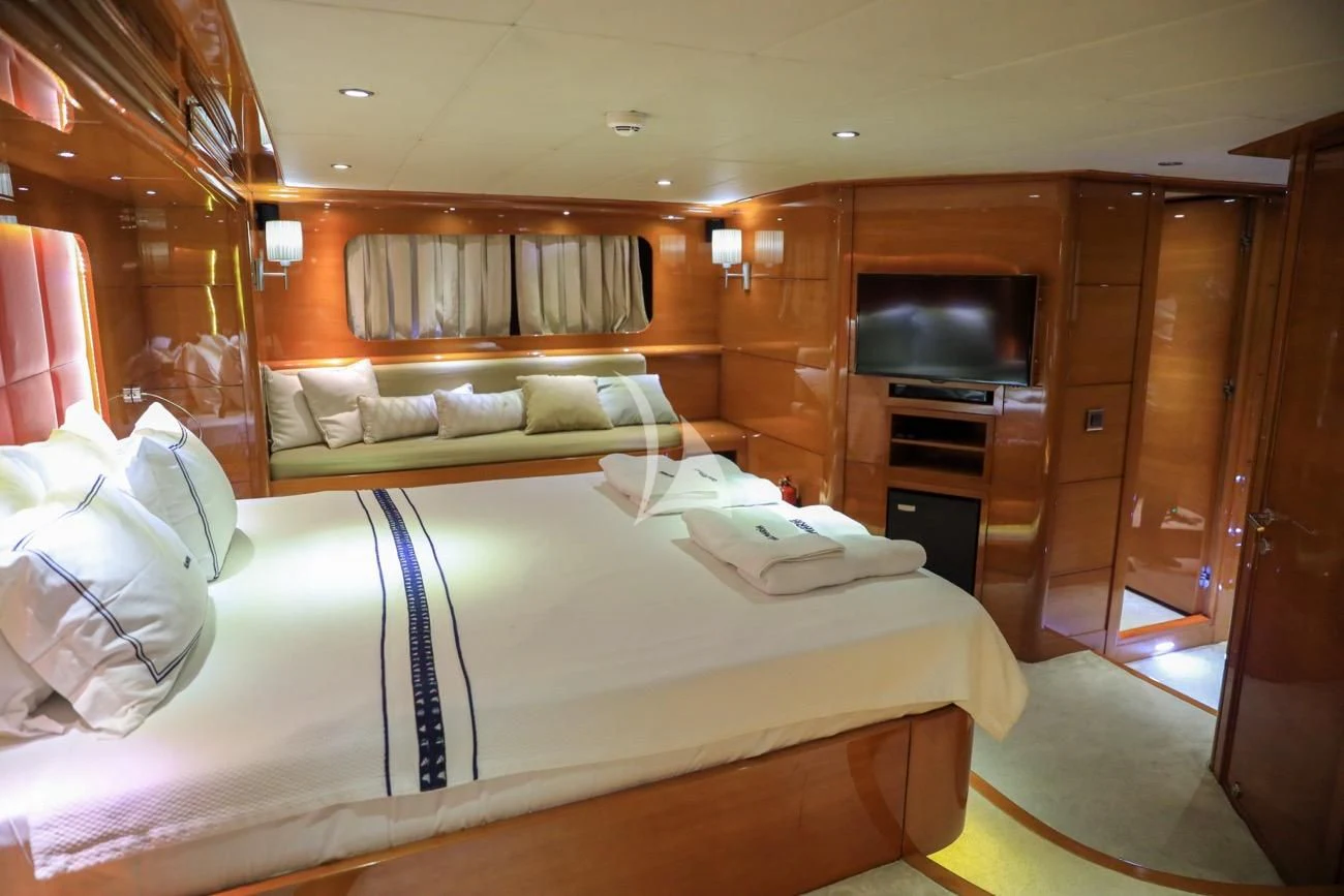 a room with a bed and a television aboard CANARIA Yacht for Sale