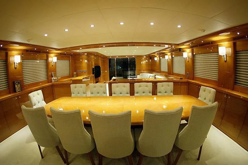 a large room with chairs and tables aboard CANARIA Yacht for Sale