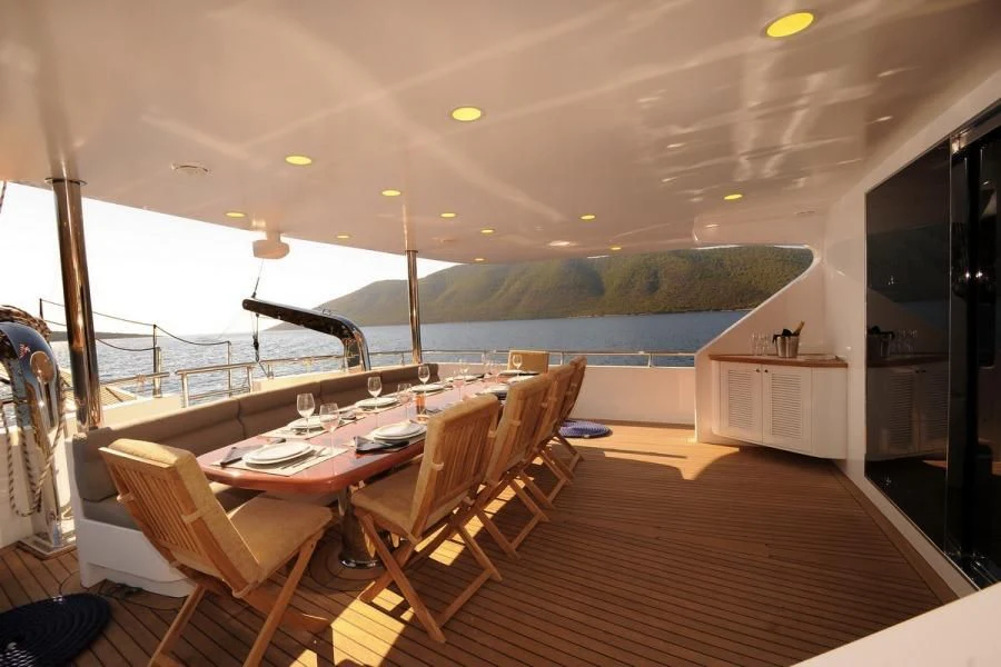 a room with a table and chairs aboard CANARIA Yacht for Sale