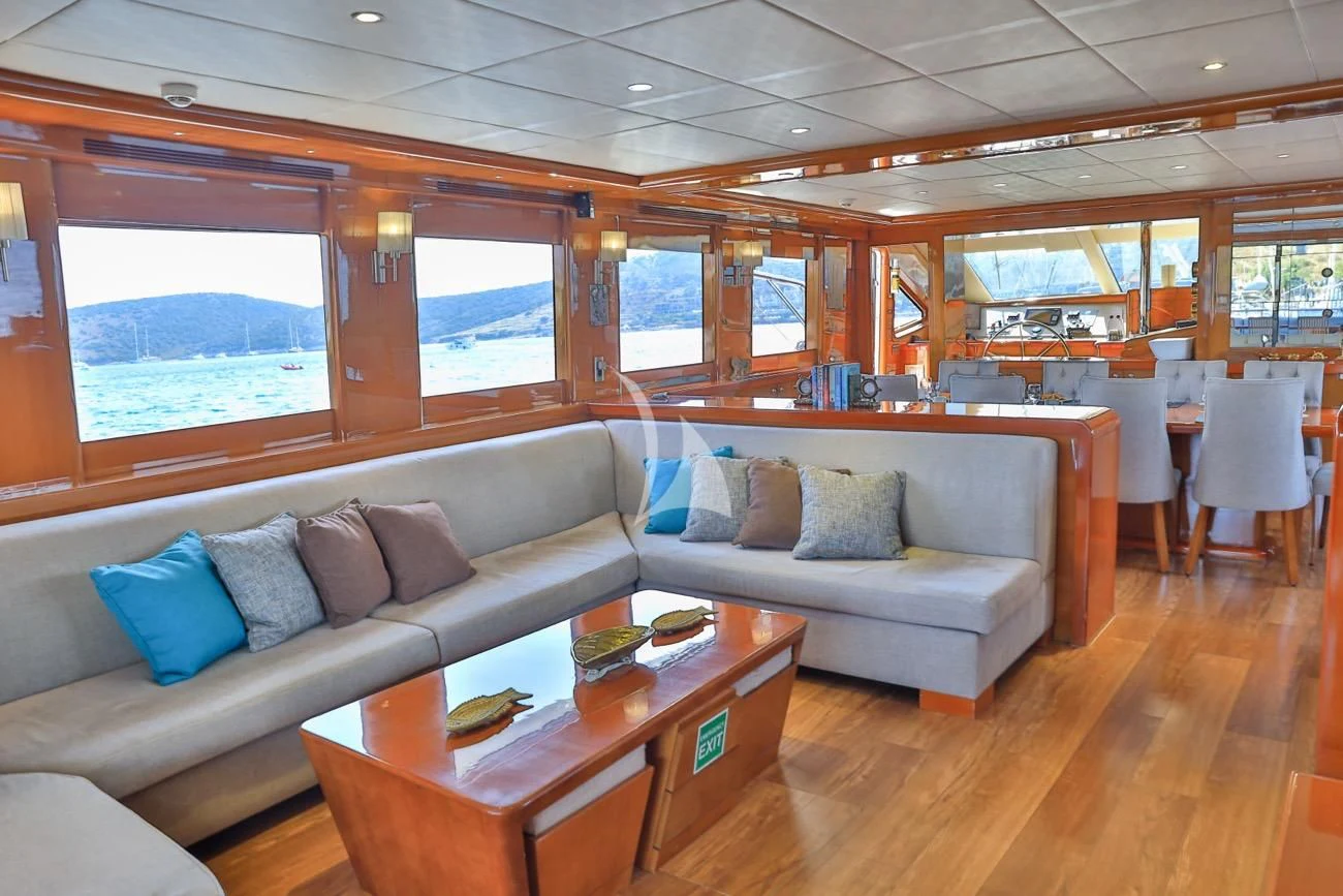 a living room with a couch and a table aboard CANARIA Yacht for Sale