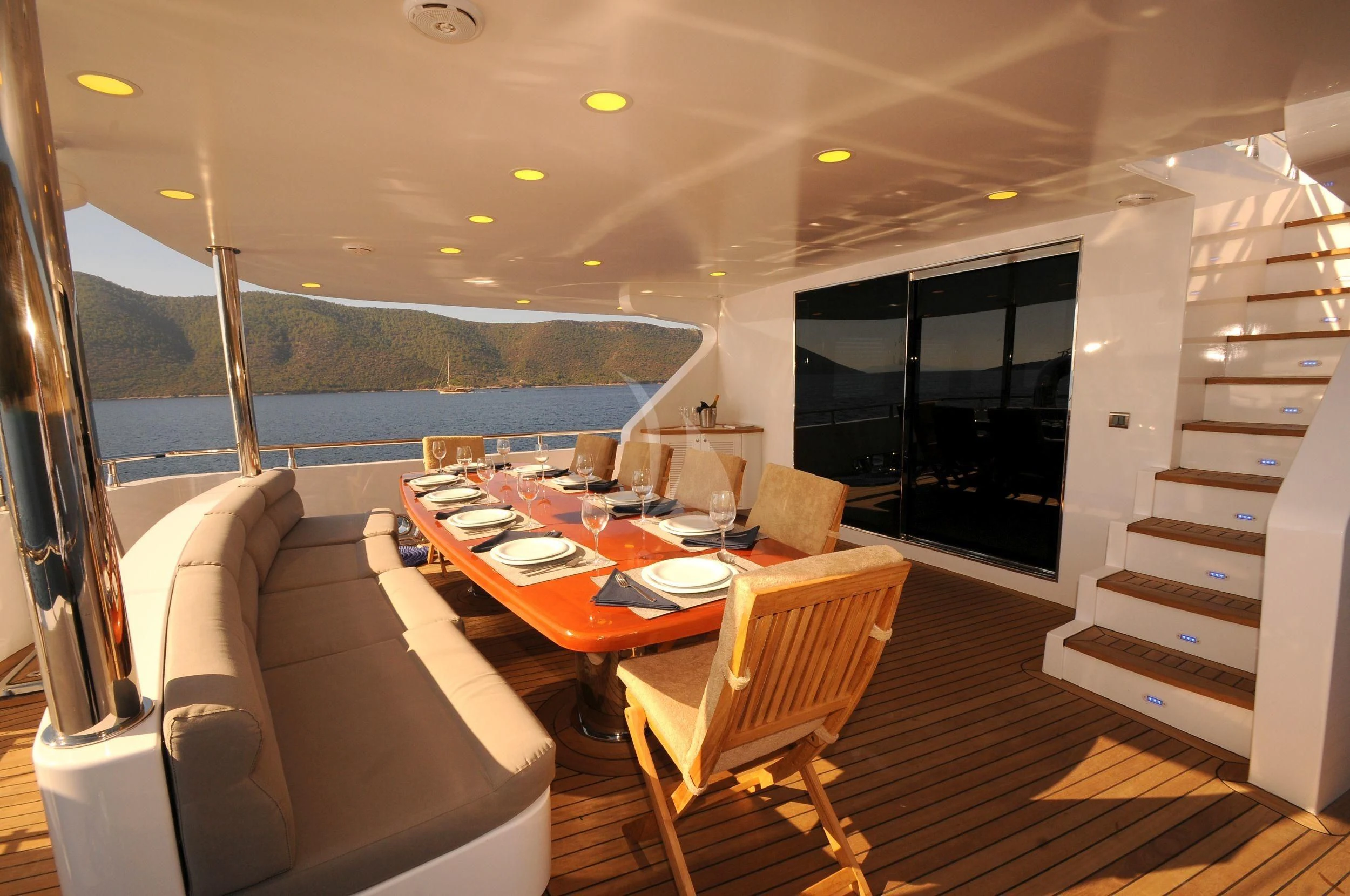 a dining room with a view of the ocean aboard CANARIA Yacht for Sale