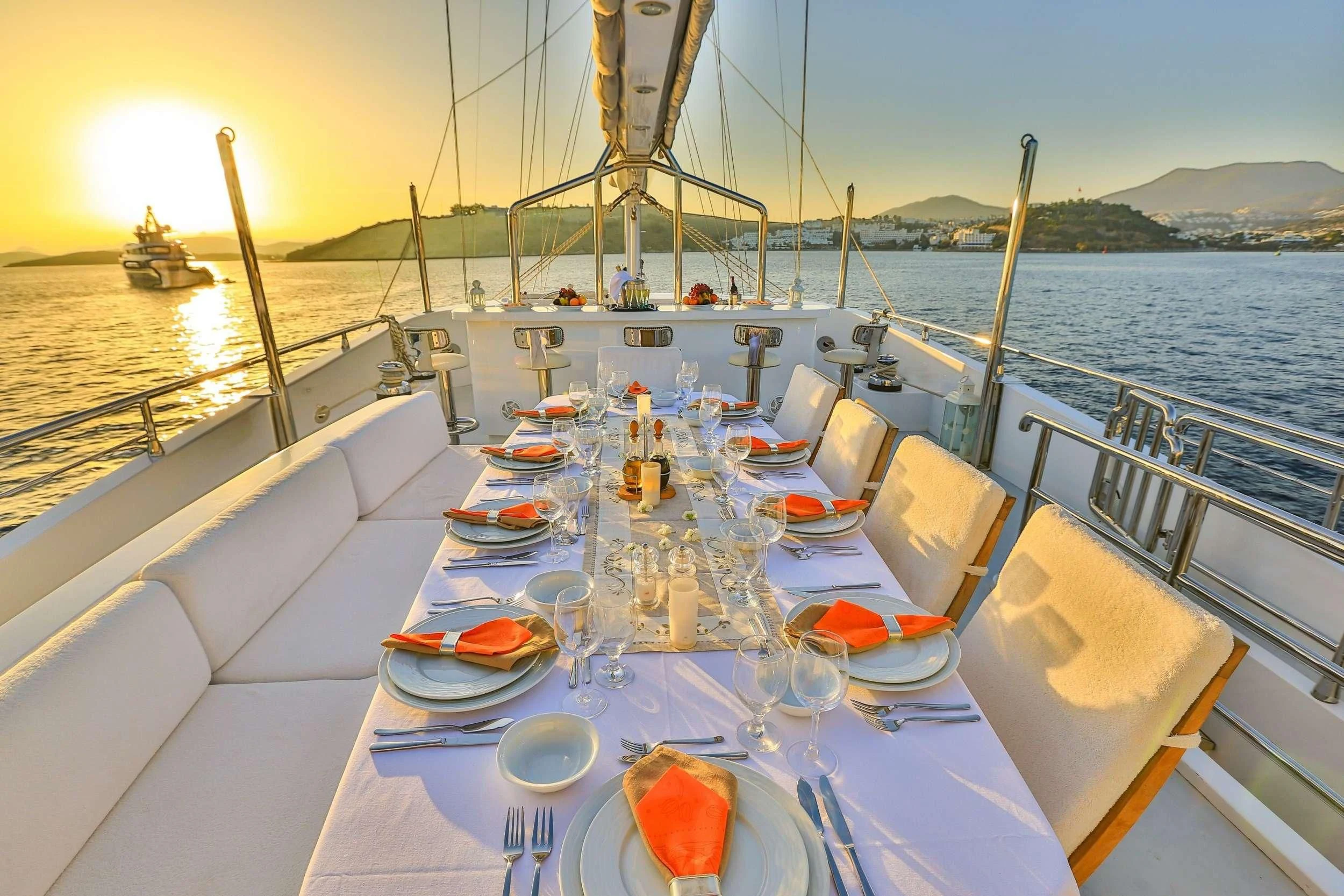 a table set for a dinner on a boat aboard CANARIA Yacht for Sale