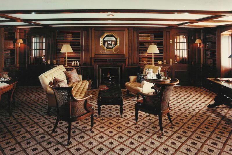 a living room with a fireplace aboard VIRGINIAN Yacht for Sale