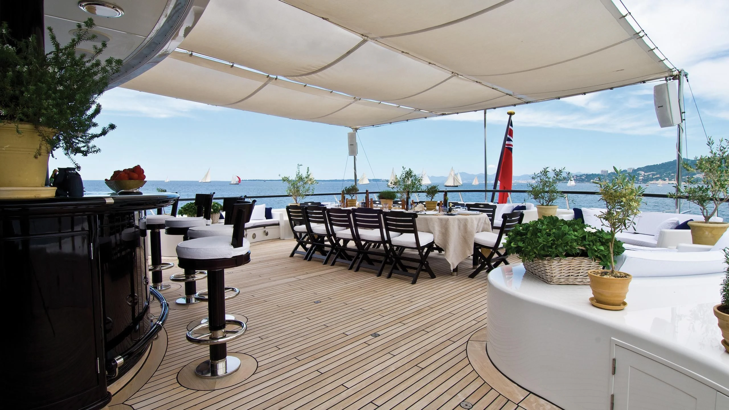a patio with tables and chairs aboard VIRGINIAN Yacht for Sale