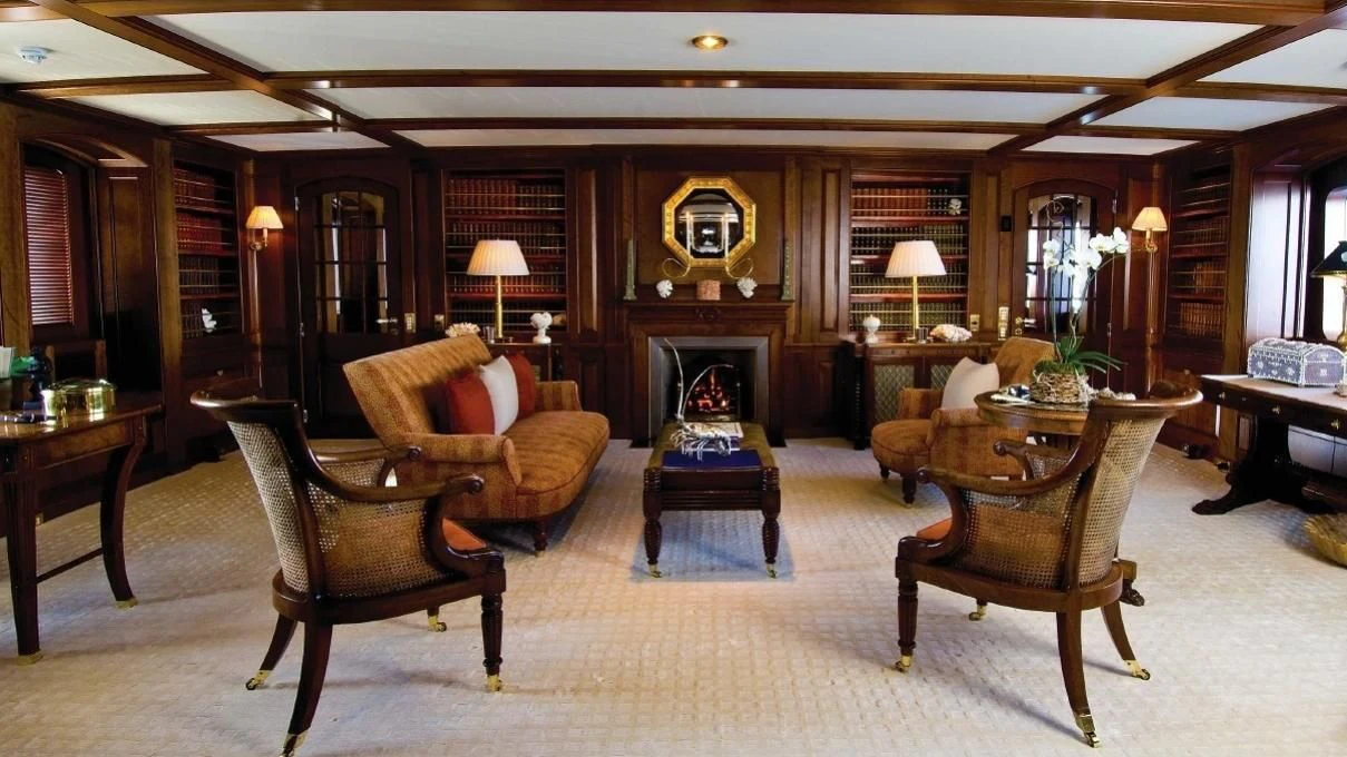 a living room with a fireplace aboard VIRGINIAN Yacht for Sale