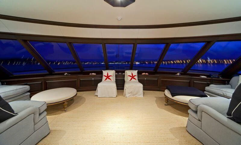 a room with couches and a view of the ocean aboard VIRGINIAN Yacht for Sale