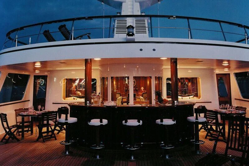 a restaurant with tables and chairs aboard VIRGINIAN Yacht for Sale