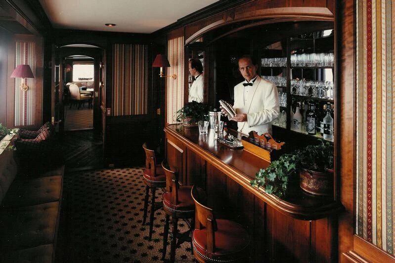 a person standing at a bar aboard VIRGINIAN Yacht for Sale