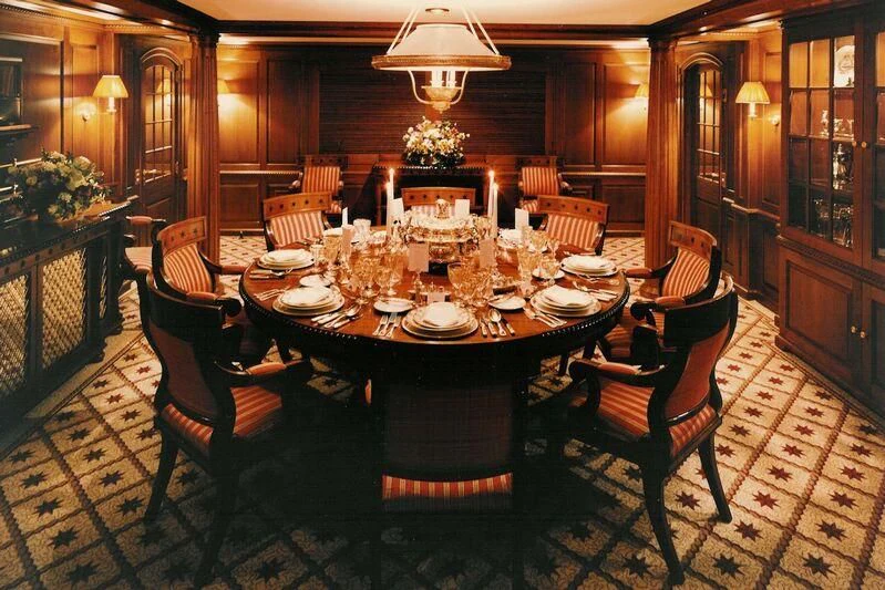 a dining room table set for a dinner party aboard VIRGINIAN Yacht for Sale