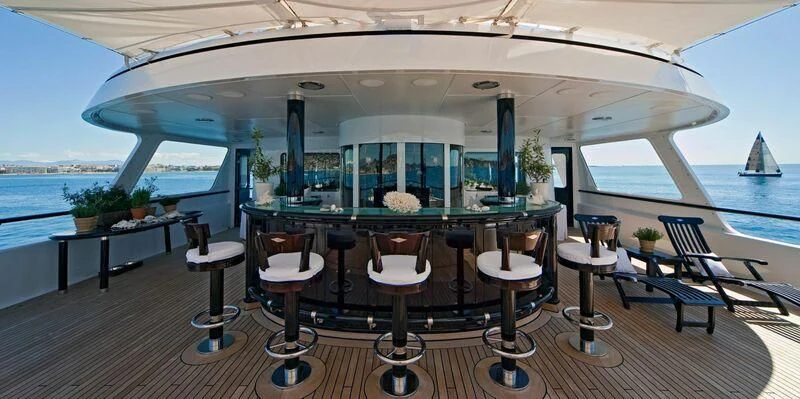 a room with tables and chairs aboard VIRGINIAN Yacht for Sale