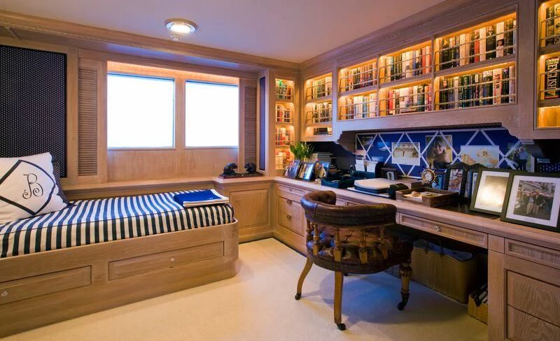 a bedroom with a desk and a bed aboard VIRGINIAN Yacht for Sale