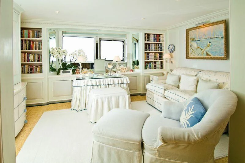 a living room with a white couch and a table aboard VIRGINIAN Yacht for Sale