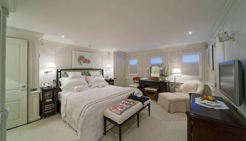 a bedroom with a bed and a tv aboard VIRGINIAN Yacht for Sale