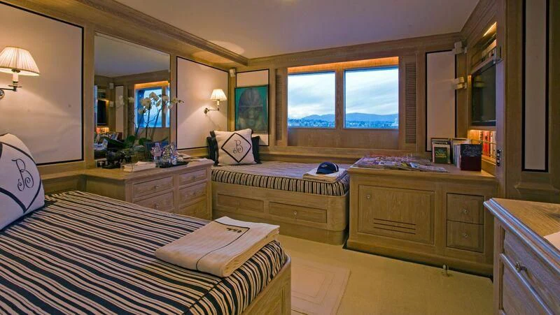 a bedroom with a bed and a dresser aboard VIRGINIAN Yacht for Sale