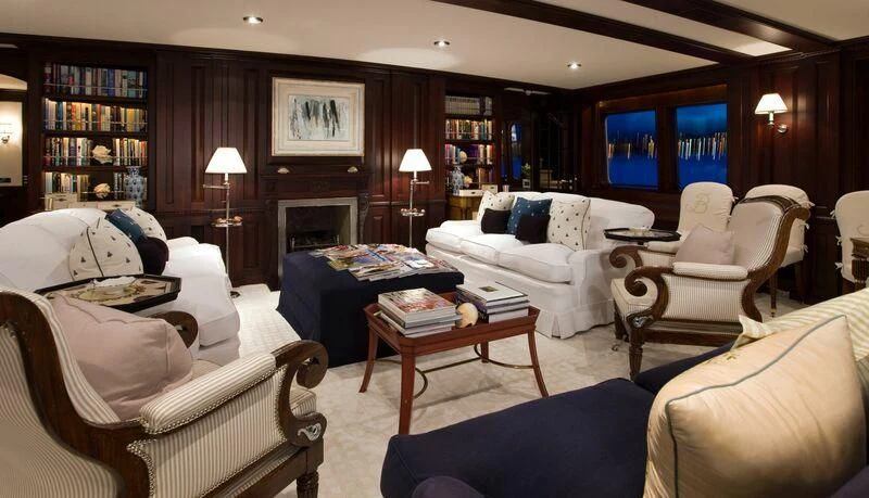 a living room with a fireplace aboard VIRGINIAN Yacht for Sale