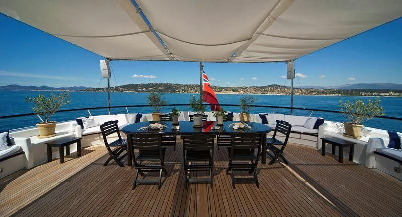 a patio with a table and chairs aboard VIRGINIAN Yacht for Sale