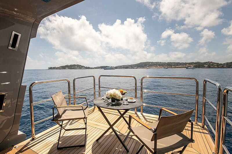 a boat with a table and chairs on the deck aboard ARBEMA Yacht for Sale